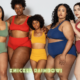 five women stand facing the camera with their arms around each other. They wear bras and knickers in different colours: green, red, yellow, blue and maroon.