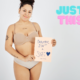 a woman stands in underwear holding a sign that reads "beautiful isn't a size". Overlaid text reads "just this".