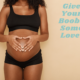 A heavily pregnant woman makes a heart shape with her hands over her belly. She wears a black stretch bra and short style underpants. Text reads "give your boobs some love!"