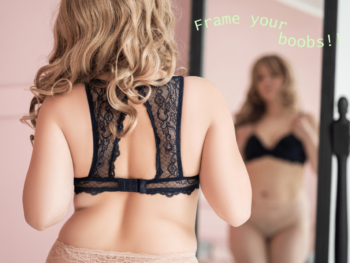 rear view of a woman in a bra looking at her reflection in a mirror.